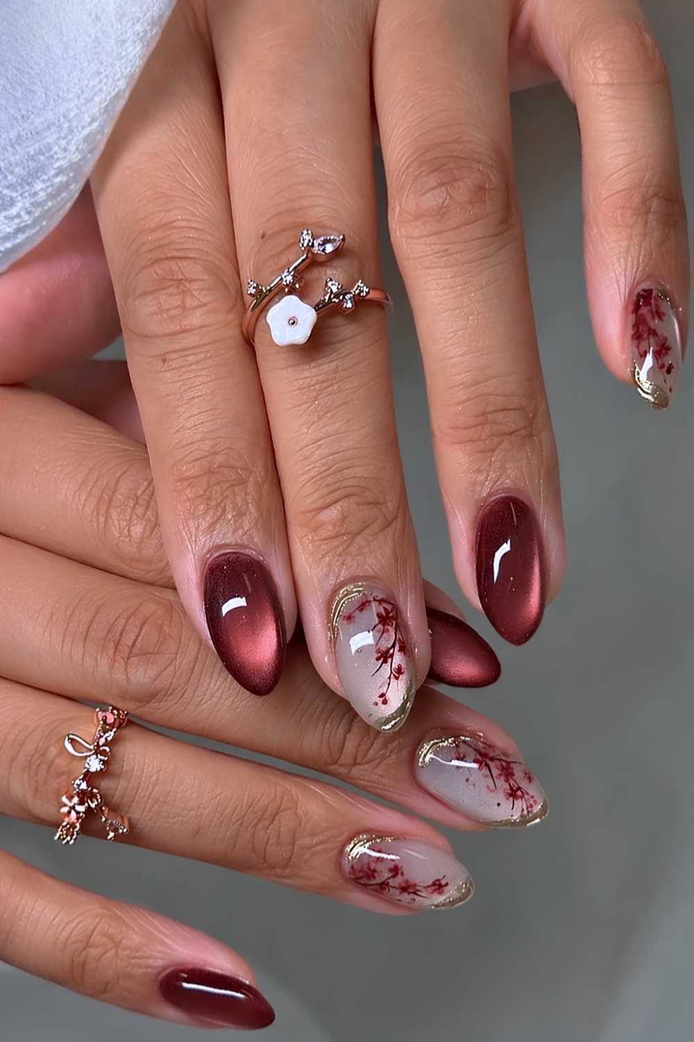 Rote Cat Eye Naegel mit Kirschblueten
