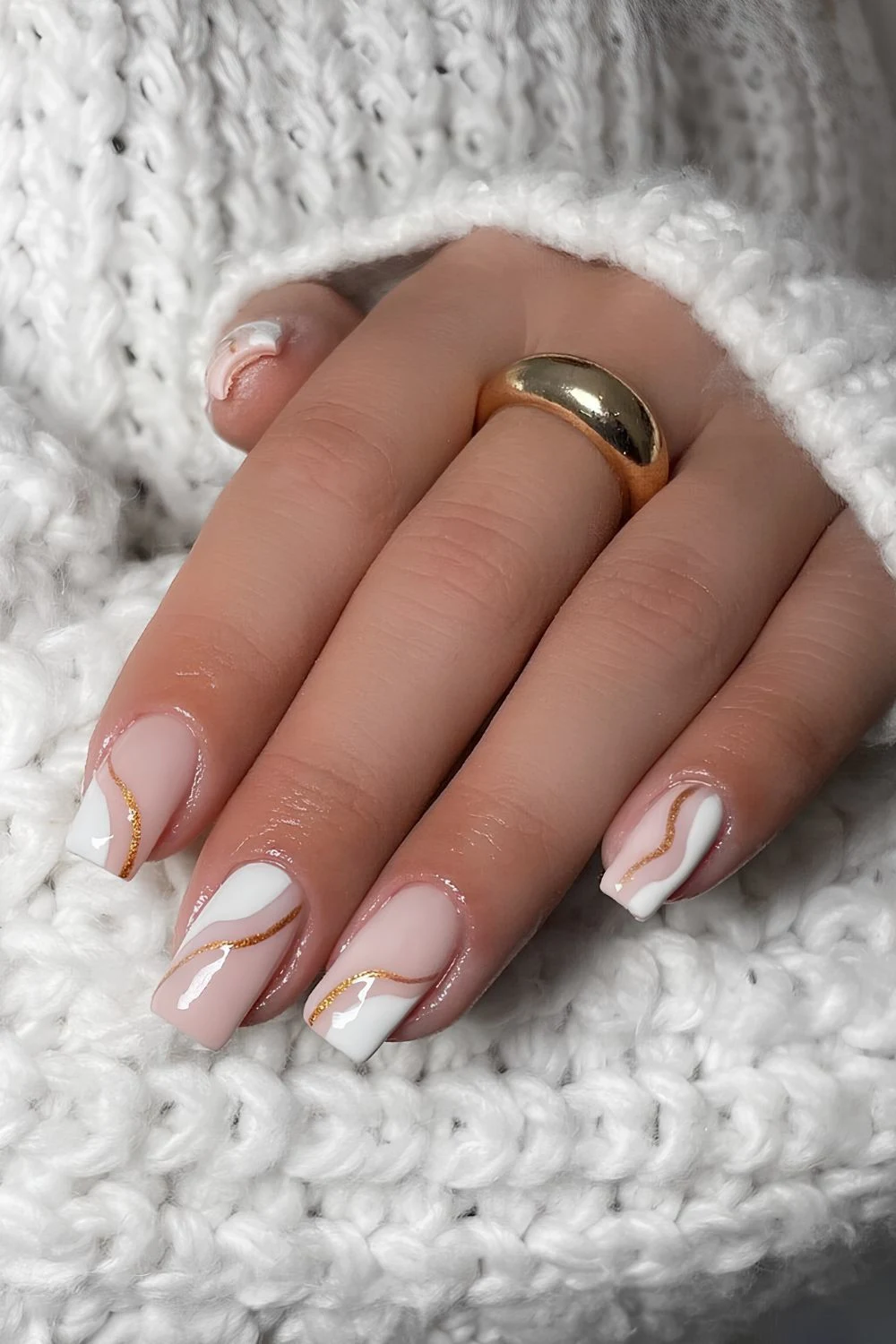 Winterliche weiße Nägel mit goldenen Linien