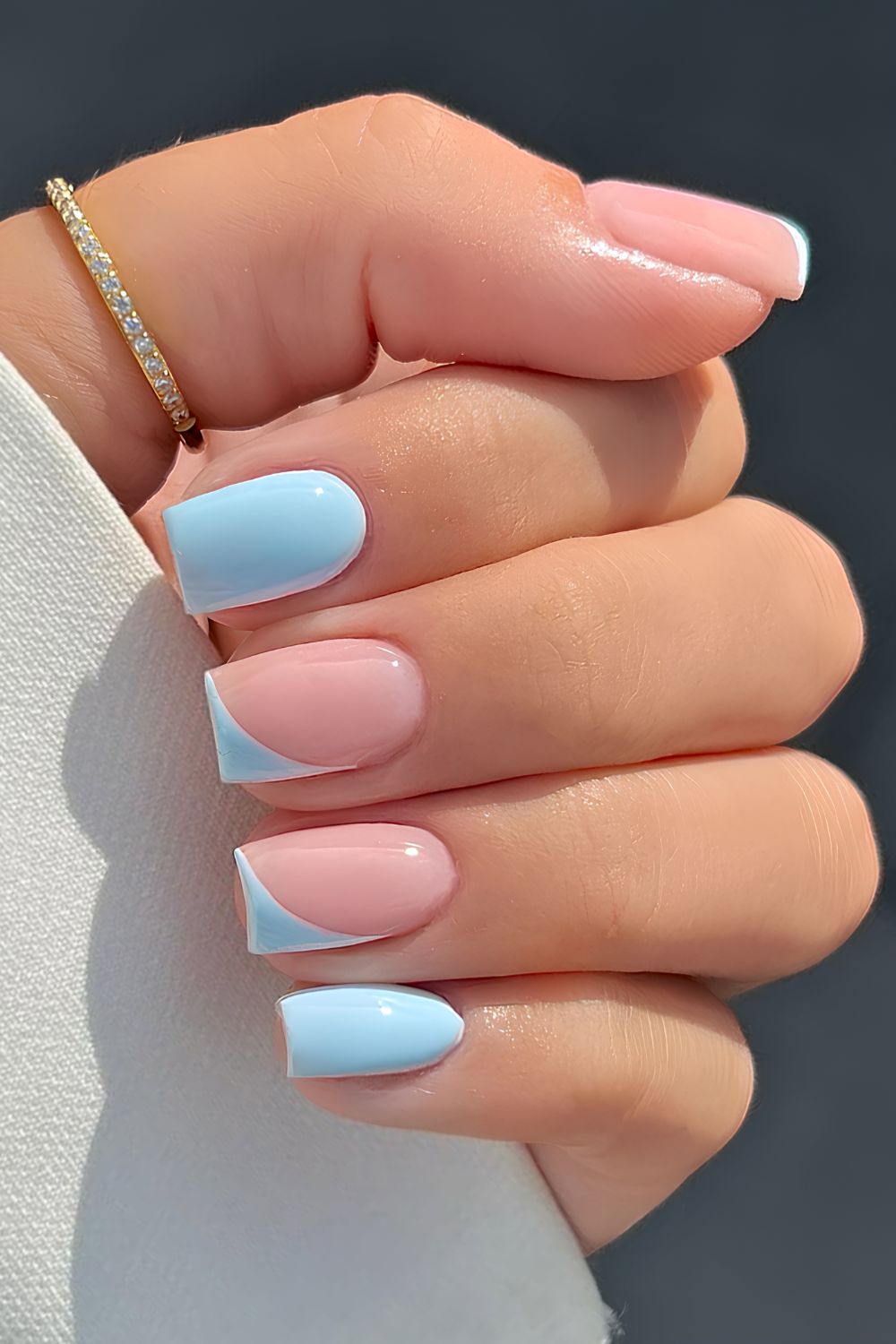 Hellblaue Naegel mit schraegen French Tips