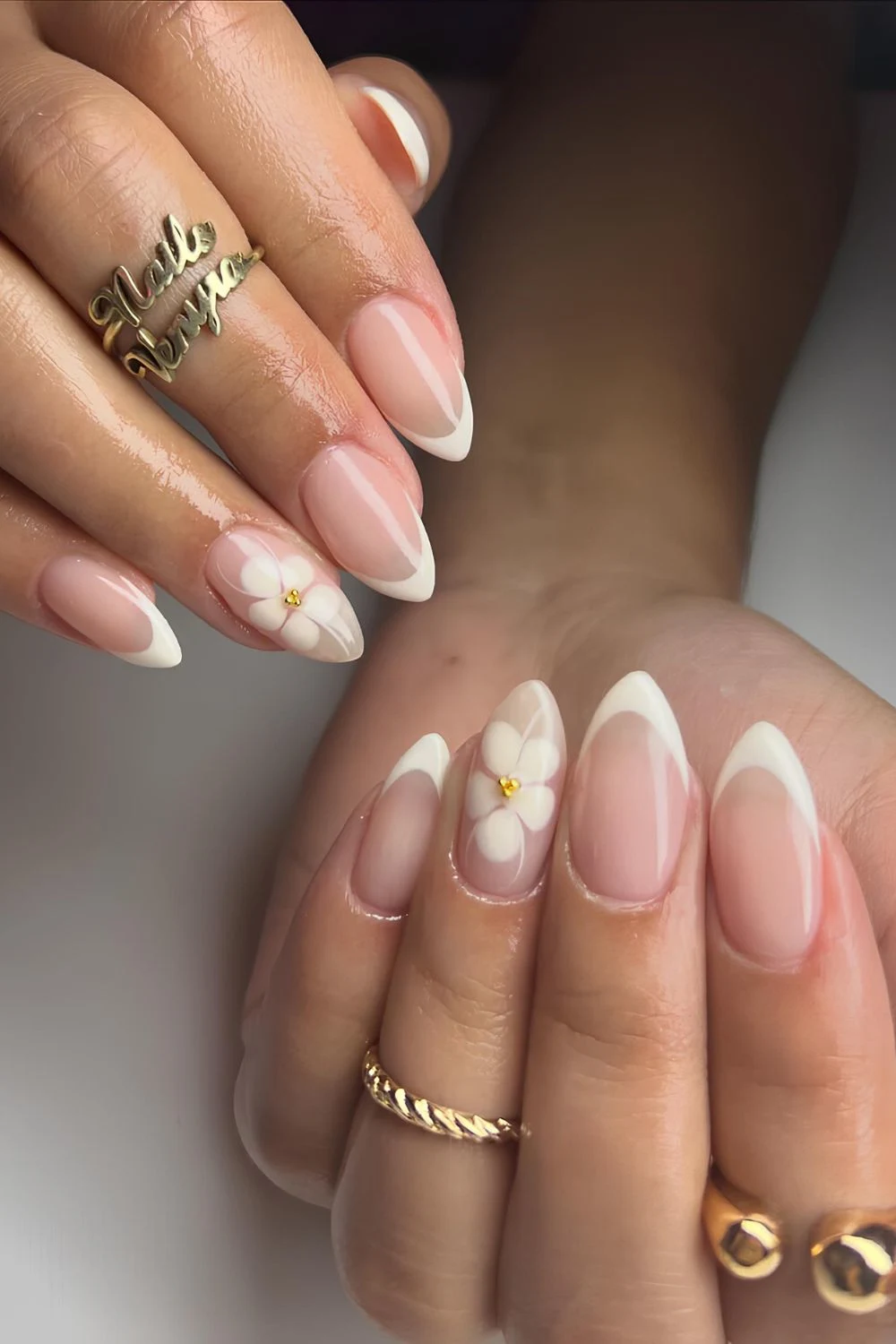 Cremige weiße French Almond Nägel mit Blütenakzent