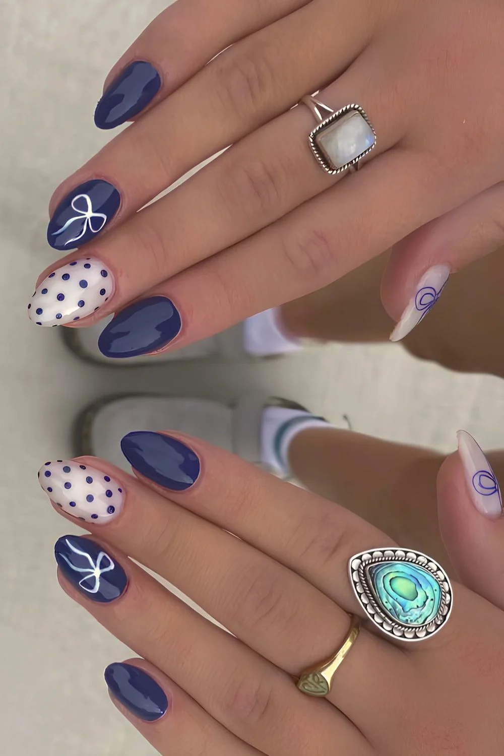 Dunkelblaue Mani mit Schleifen und Mikro-Pünktchen
