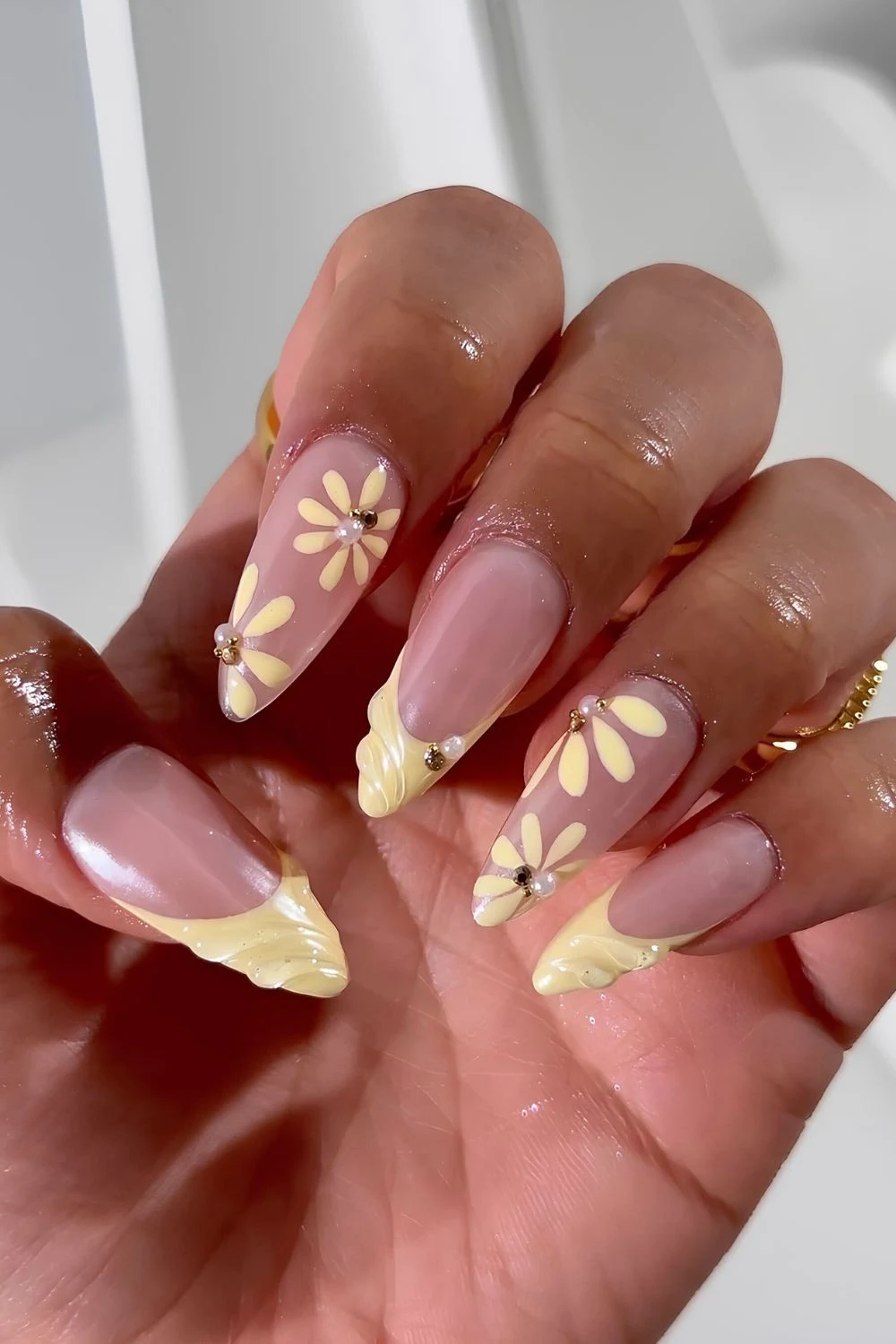 Buttergelbe-strukturierte-French-Maniküre-mit-Blumen-und-Perlen