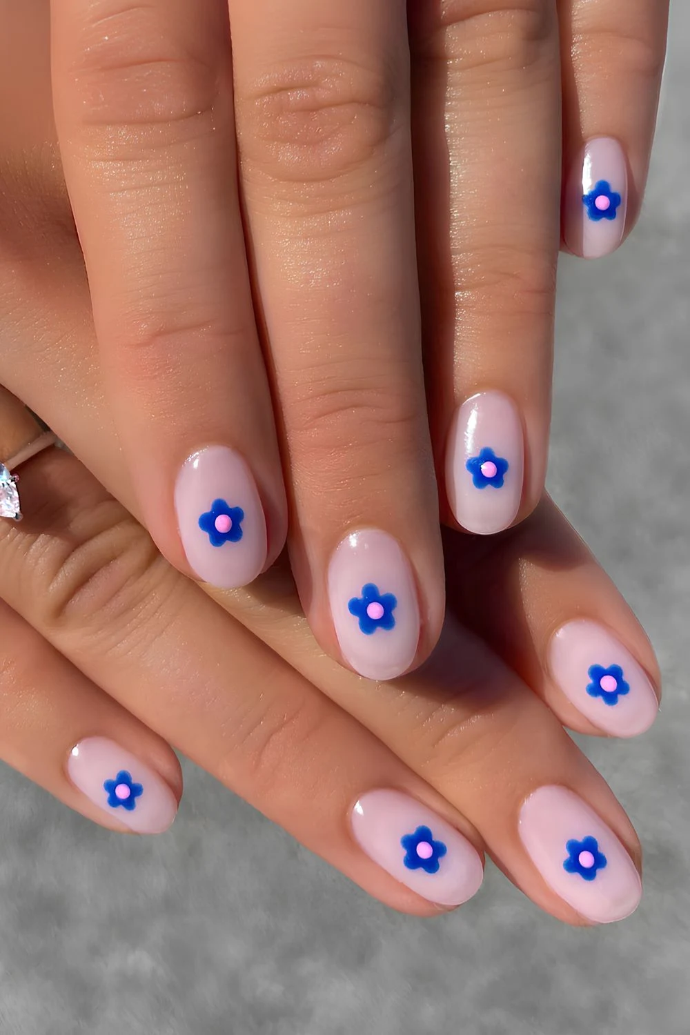 Milchig-weiße Nägel mit blauem Blumen-Design