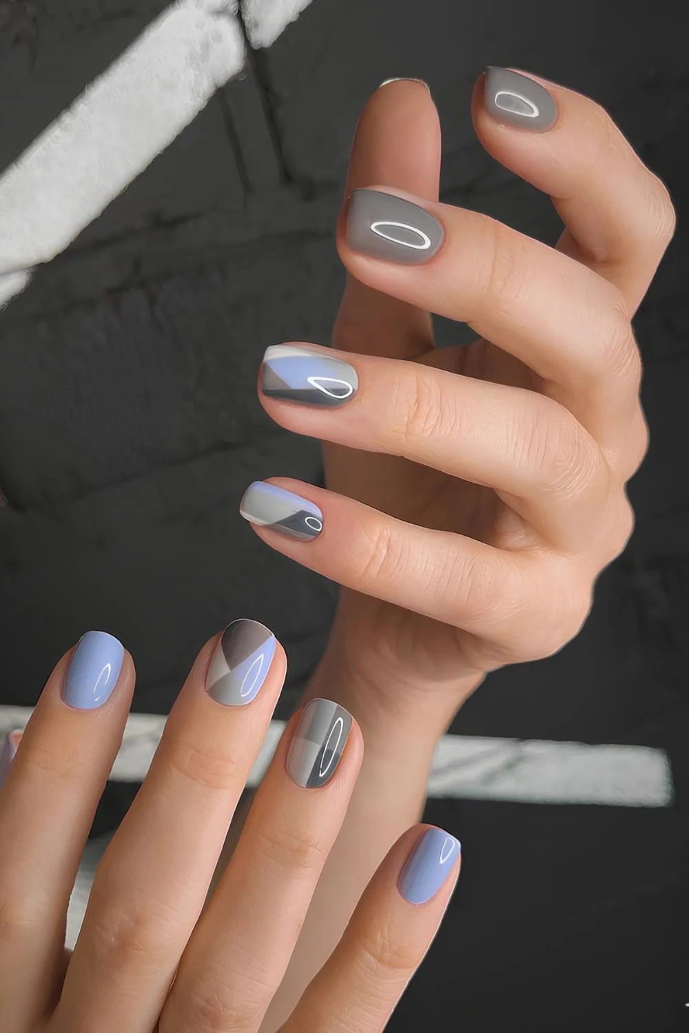 Graue Nägel mit blauen Akzenten