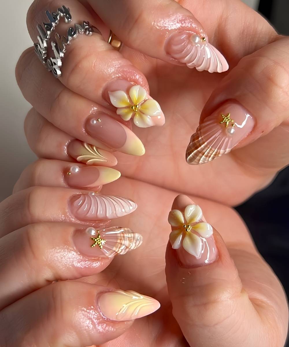 Buttergelbe Naegel mit Beach Nail Art und Blumen
