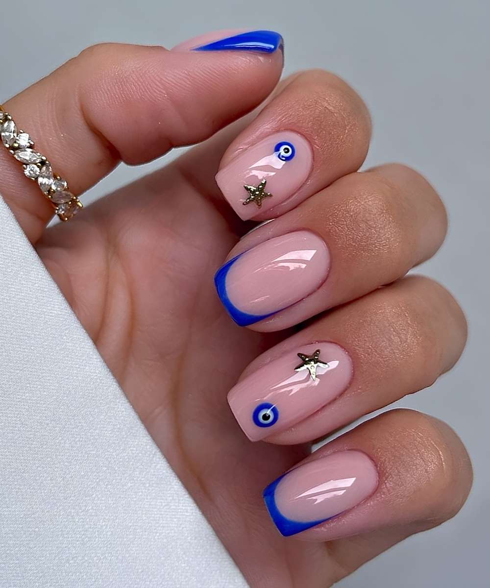 Kurze blaue French Mani mit Evil Eye Motiv