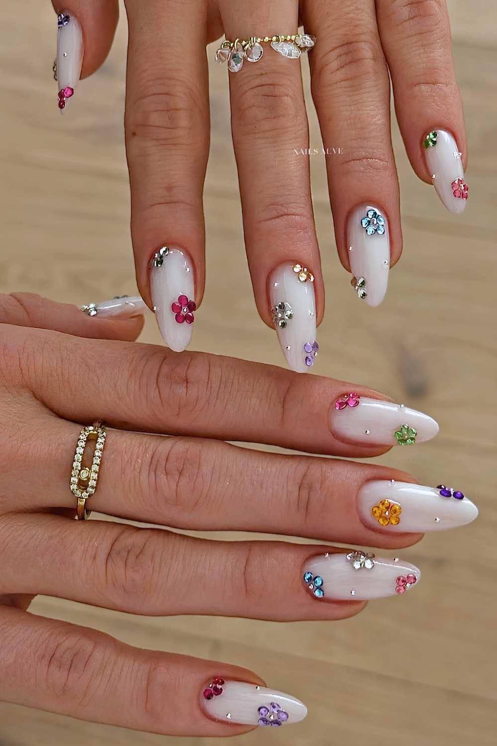 Weisse Manikuere mit bunten Strassblumen