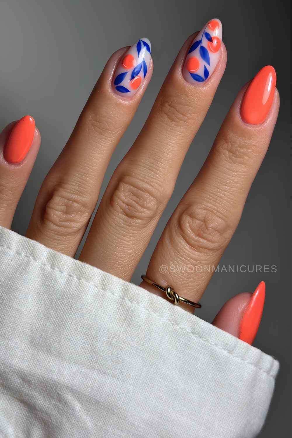 Orange blaue naegel mit frucht und blattmotiven