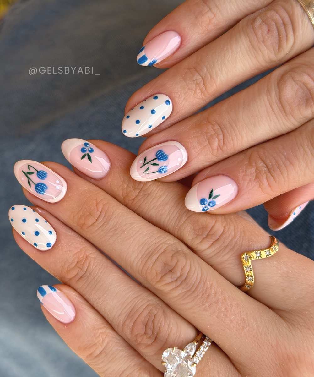 Neutrale Manikuere mit blauen Blumen und Blaubeeren