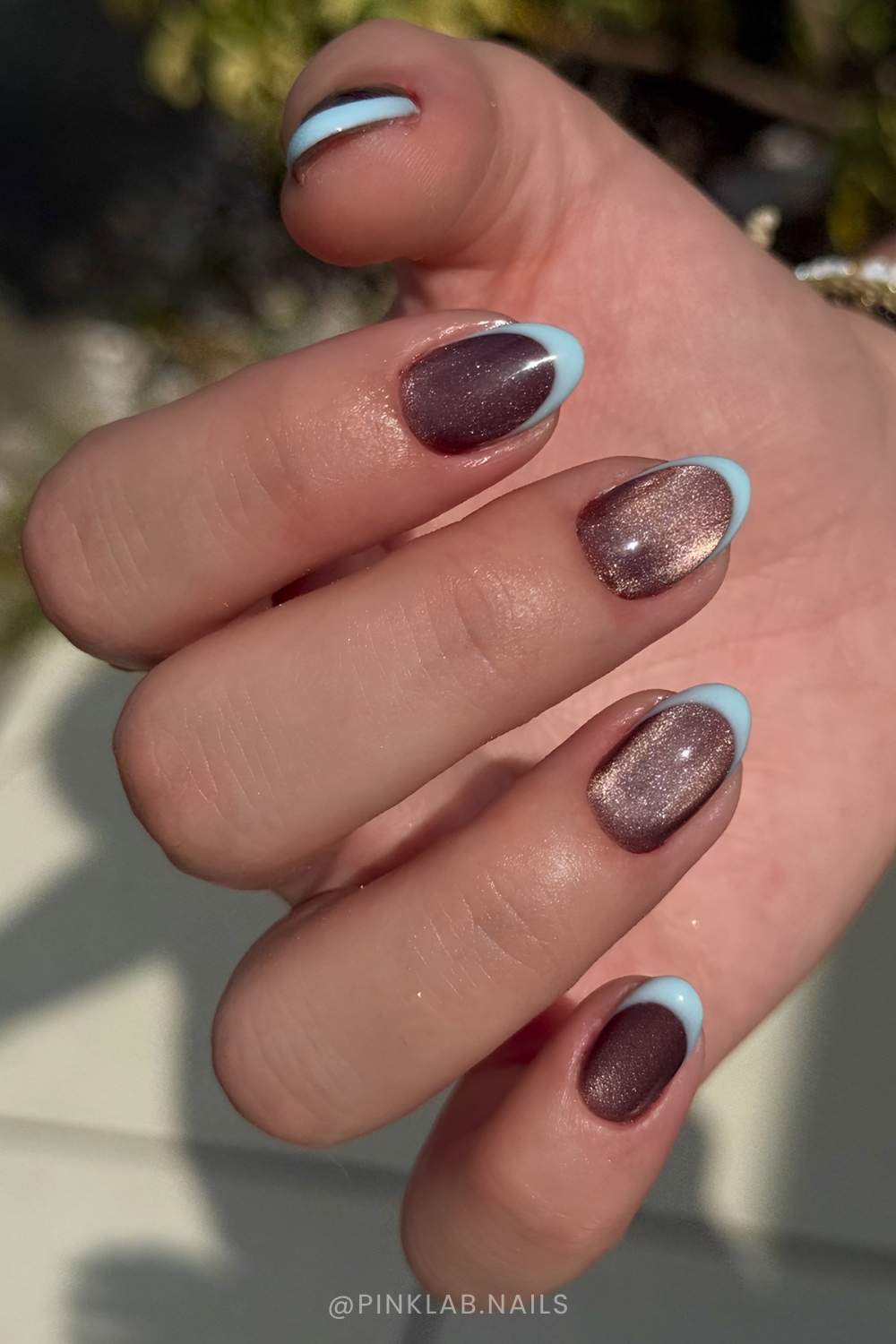 braune cat eye naegel mit blauen french spitzen
