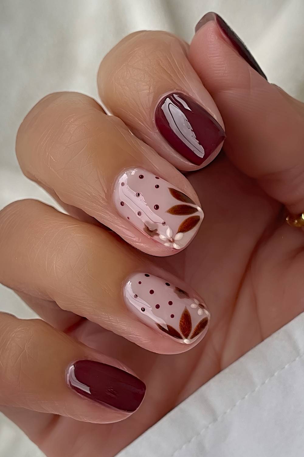 Braune Naegel mit Blumen und Blaettern