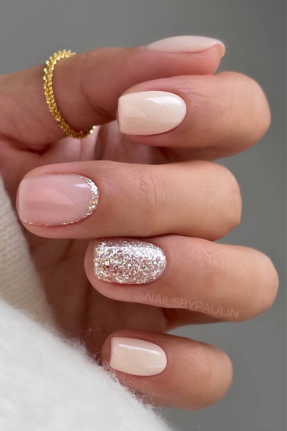 Kurze beige Naegel mit Glitzer Akzent