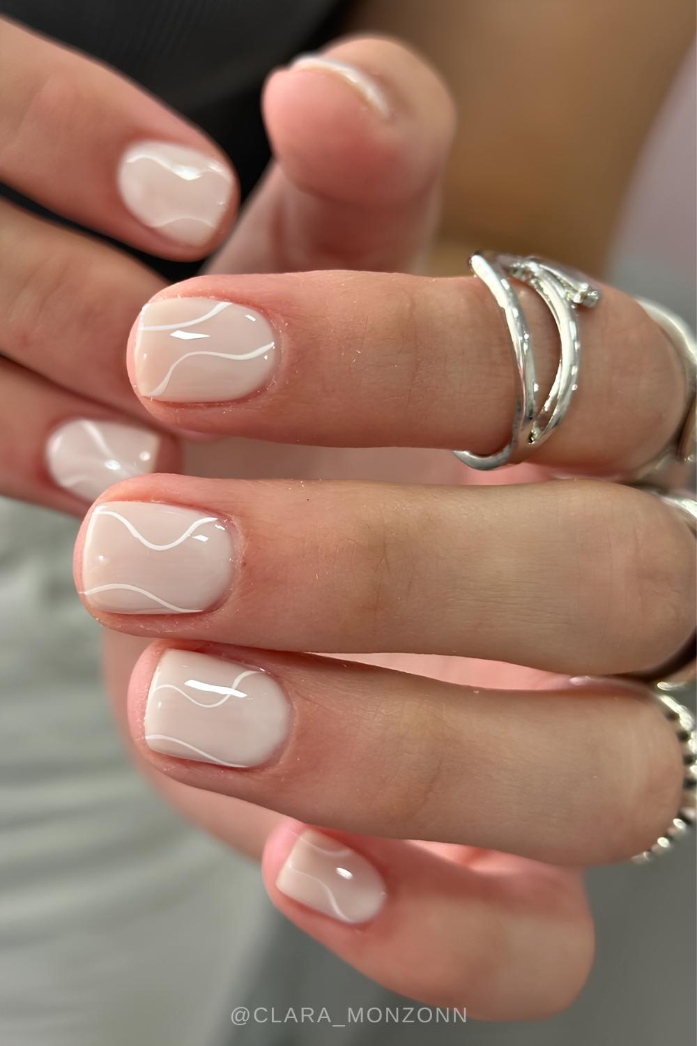 Kurze beige Naegel mit weissen Linien